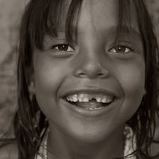 A smiling person presented as cute or charming.