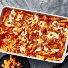 A serving of baked ziti topped with melted cheese.