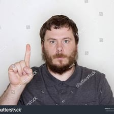 A person holding up one finger to ask someone to wait.