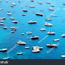Many boats gathered on a body of water