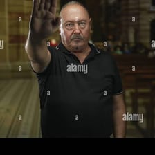 A person raising a hand while taking an oath.