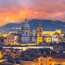 A view of Palermo with historic buildings and mountains