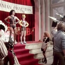 A theatrical costume scene from The Rocky Horror Picture Show illustrating its camp aesthetic.