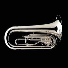 Several musicians playing large tubas in a marching band