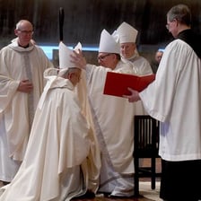 An abbot wearing religious robes in a monastery setting