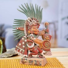A statue or artistic depiction of Xipe Totec, an Aztec deity.