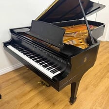 A large grand piano with its lid raised