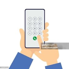 A hand entering a phone number on a smartphone