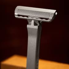 A handheld razor with a replaceable shaving head.