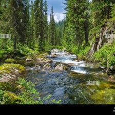 A narrow stream flowing through a mountainous landscape.