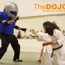 A martial-arts instructor leading students in a dojo