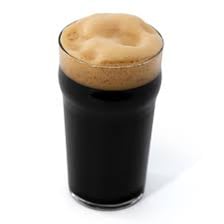 A pint of dark stout beer with a creamy head