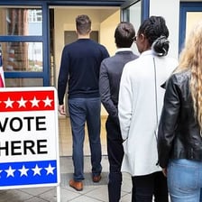 Voters casting ballots at a polling place.