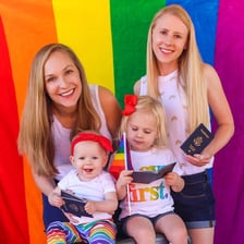Two women care for a child together.