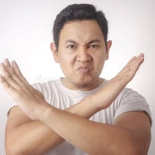 Person expressing disapproval with a scolding gesture