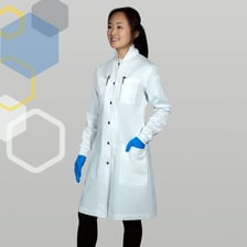 A scientist wearing a white lab coat in a laboratory.