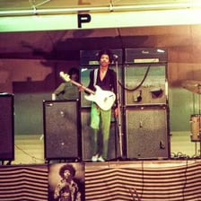 A stack of guitar amplifiers on a rock concert stage.