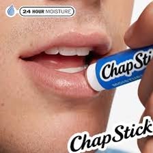 A tube of lip balm being applied to a person's lips
