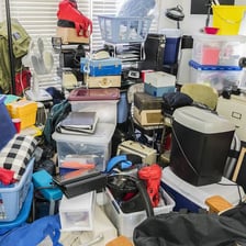 Person clearing unwanted objects from a room