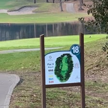 A long golf fairway stretching toward the green.
