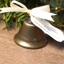 Metal bells and a whistle displayed as simple decorative objects