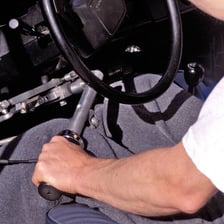 A car's manual gearshift and three-pedal setup, including the clutch.