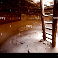 The interior of a traditional Pueblo kiva with a central fire opening