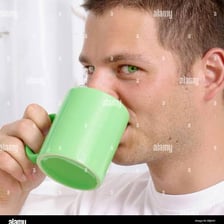 A person taking a small sip from a cup.