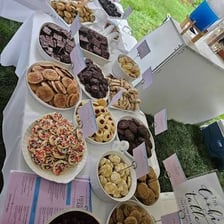 Homemade cookies arranged on a bake-sale table.