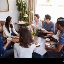 Two friends having a casual conversation at a coffee shop