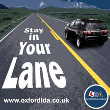 A car traveling within clearly marked road lanes.