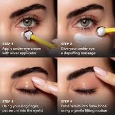 A fingertip applying a small amount of eye cream