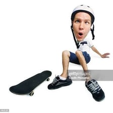 A skateboarder falling during a wipeout.