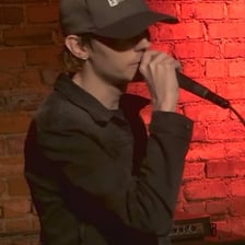 A musician performing a blend of emo and rap.