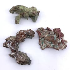 A rough rock specimen containing visible metal-bearing ore