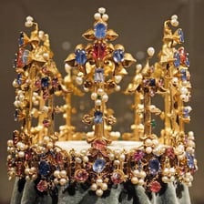 A crowned queen in a palace setting