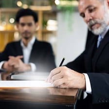A person signing a document as confirmation.
