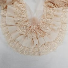 Decorative fabric trim added to a piece of clothing.