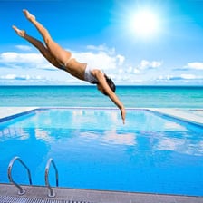 A person plunging into a swimming pool