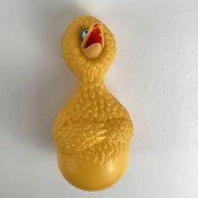 A yellow rubber duck floating in a bathtub.