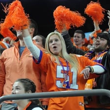 Cheerleaders encouraging a sports team in a stadium.