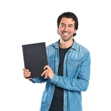 A man holding a book that belongs to him