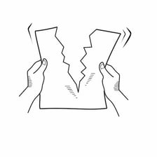 Hands ripping a sheet of paper into pieces.