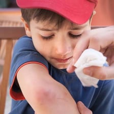 A child wearing a small adhesive bandage after a minor injury