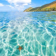 A scenic island coastline associated with a French-speaking region
