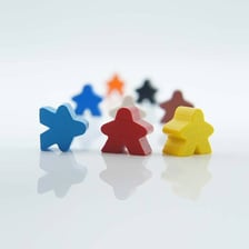 A small wooden person-shaped board-game token