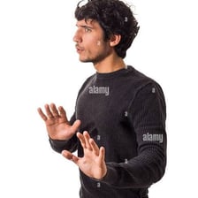 A person holding up a hand to signal wait