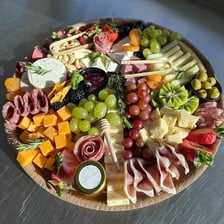 A charcuterie board with assorted sliced meats