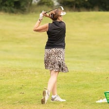 A golfer enjoying a leisurely round on a golf course.
