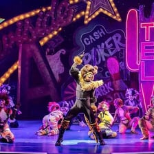 A stage scene from the musical Cats featuring its feline characters